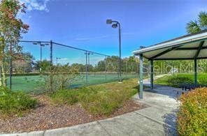 view of tennis court with fence