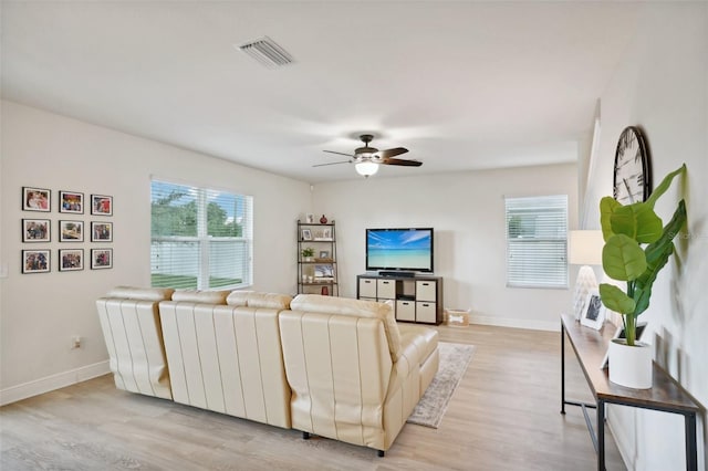 living room with ceiling fan, a healthy amount of sunlight, and light hardwood / wood-style floors