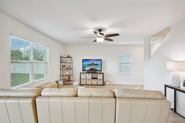 living room featuring ceiling fan, a wealth of natural light, and light hardwood / wood-style flooring