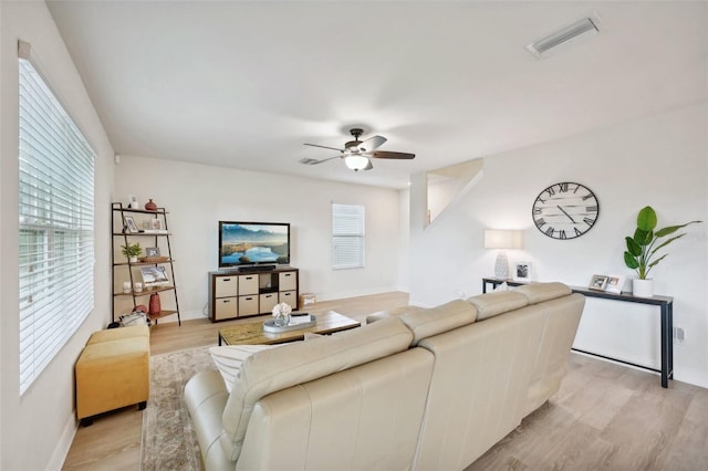 living room with ceiling fan and light wood-type flooring