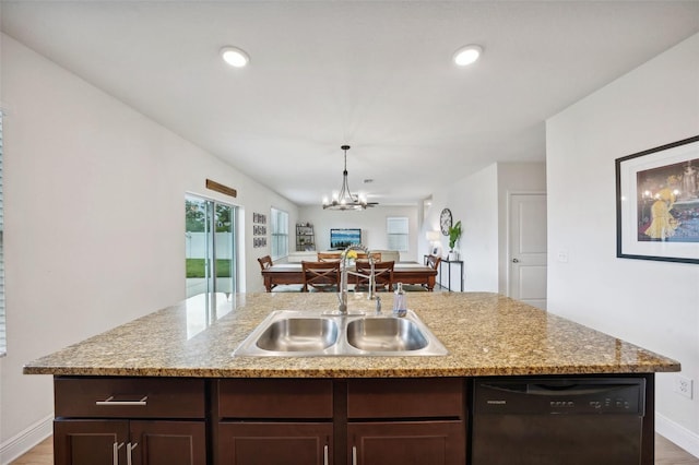 kitchen with black dishwasher, an island with sink, sink, a chandelier, and dark brown cabinets