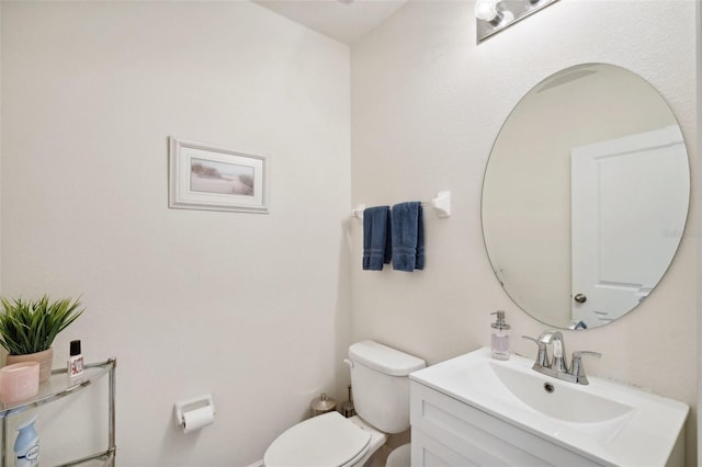 bathroom with toilet and vanity