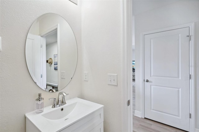 bathroom with hardwood / wood-style flooring and vanity