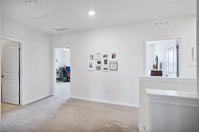 corridor featuring light colored carpet