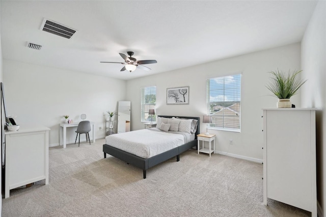 bedroom featuring ceiling fan and light carpet