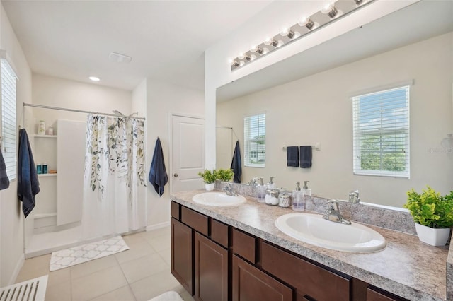 bathroom with a shower with curtain, tile patterned flooring, vanity, and a wealth of natural light