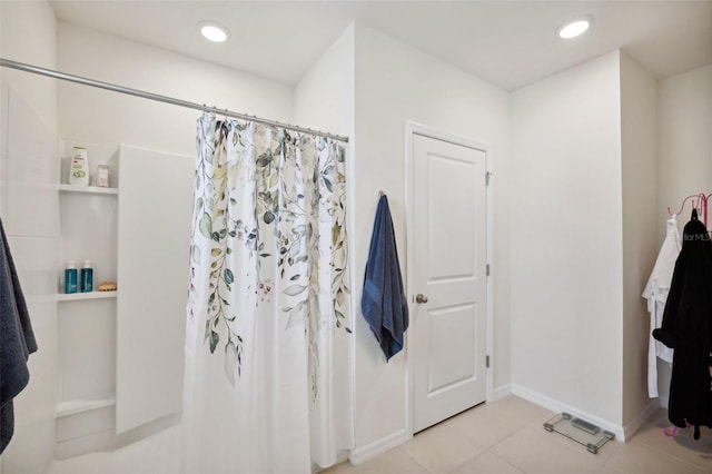 bathroom with tile patterned floors and walk in shower