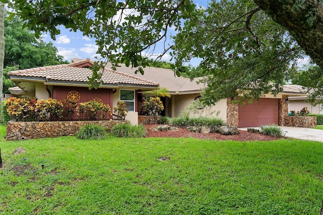 ranch-style home featuring a front yard and a garage