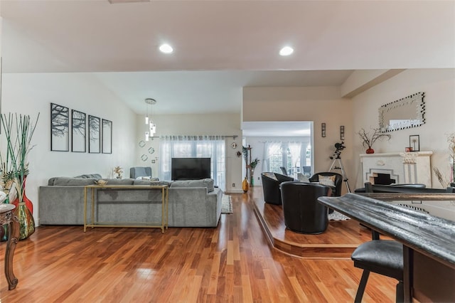 living room featuring hardwood / wood-style flooring and lofted ceiling