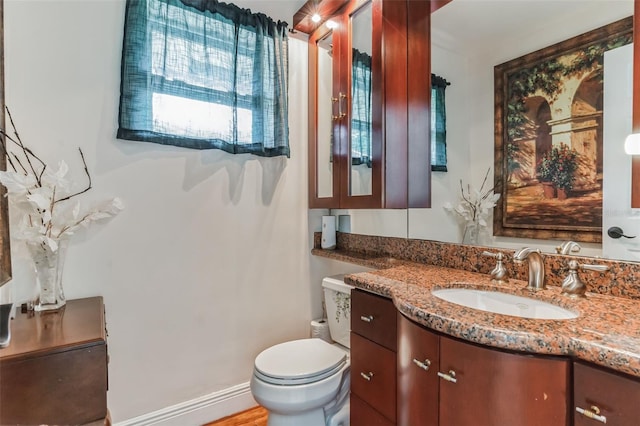 bathroom featuring vanity and toilet