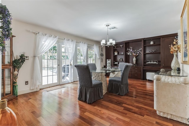 dining space featuring dark hardwood / wood-style floors and a notable chandelier