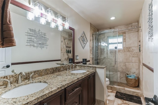 bathroom featuring an enclosed shower, vanity, and toilet