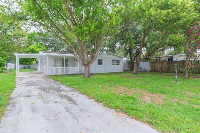 view of front facade with a front lawn and a carport