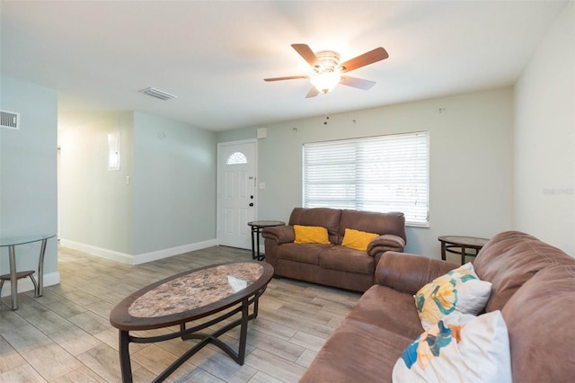 living room with ceiling fan and light hardwood / wood-style floors