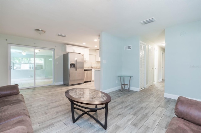 living room with light hardwood / wood-style flooring