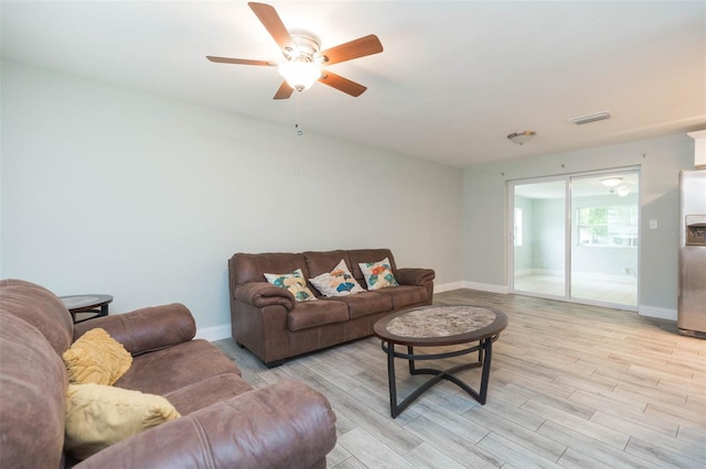 living room with light wood-type flooring and ceiling fan