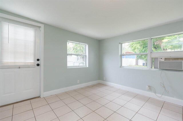 tiled spare room featuring cooling unit