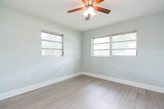 spare room with hardwood / wood-style floors and ceiling fan