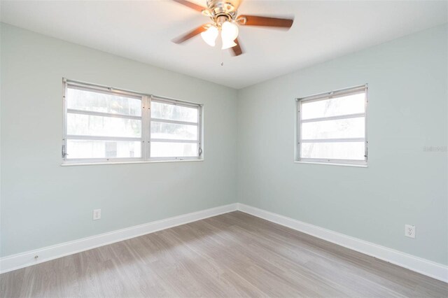 empty room featuring hardwood / wood-style floors and ceiling fan