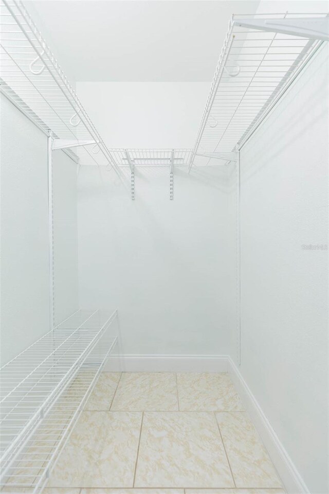 walk in closet with tile patterned flooring