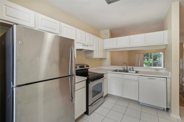 kitchen featuring white cabinetry, custom range hood, light tile patterned floors, stainless steel appliances, and sink