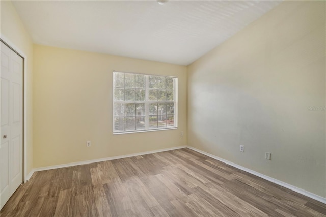 unfurnished bedroom featuring hardwood / wood-style flooring and a closet