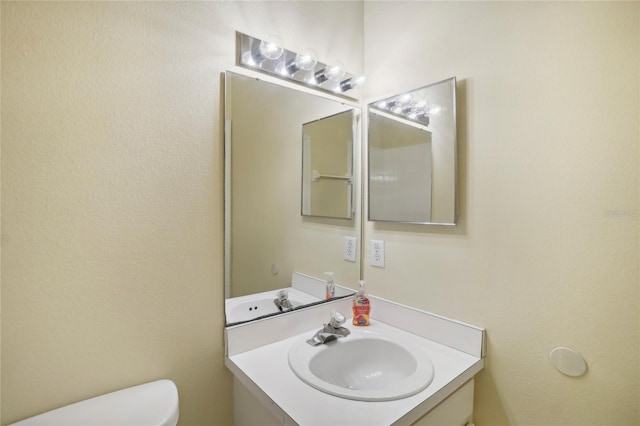 bathroom featuring toilet and vanity