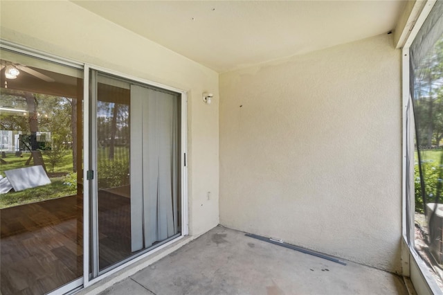 unfurnished sunroom featuring plenty of natural light and ceiling fan