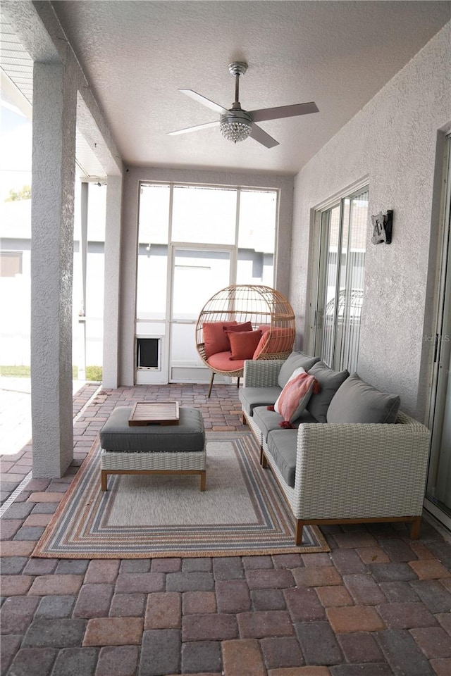 sunroom with a healthy amount of sunlight and ceiling fan