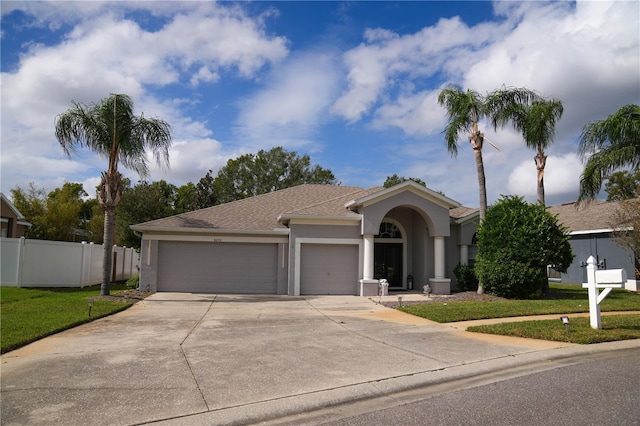 view of front of house featuring a garage and a front yard