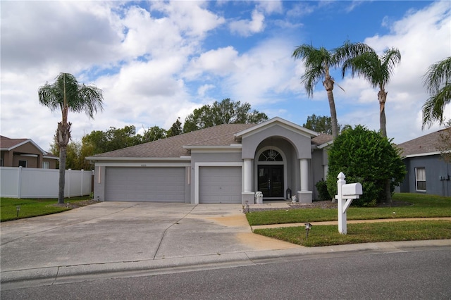 ranch-style home with a garage and a front yard