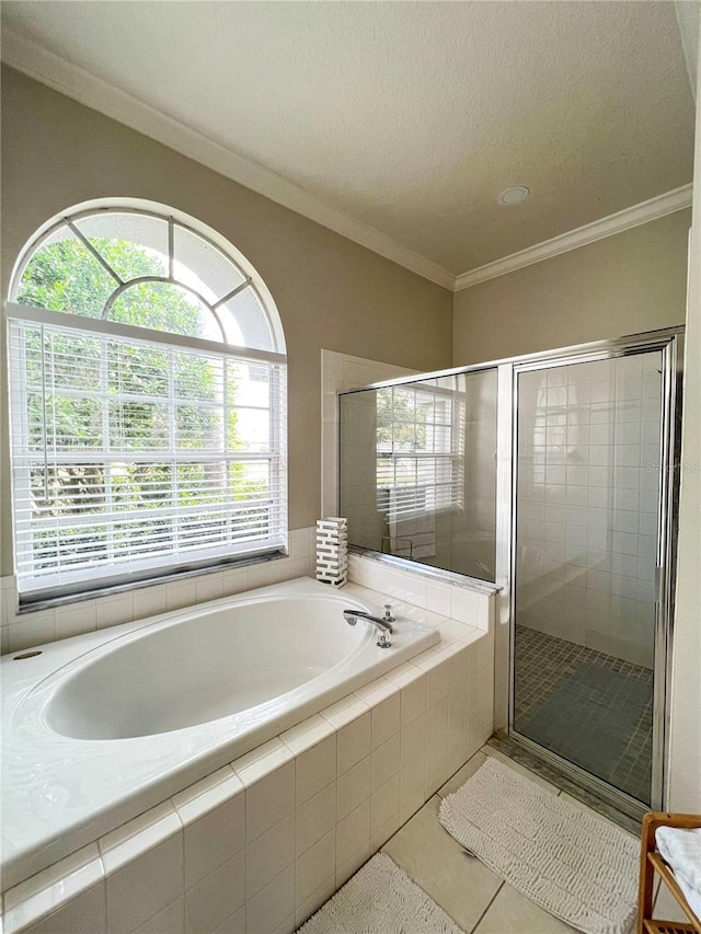 bathroom featuring independent shower and bath, a textured ceiling, tile patterned flooring, and crown molding