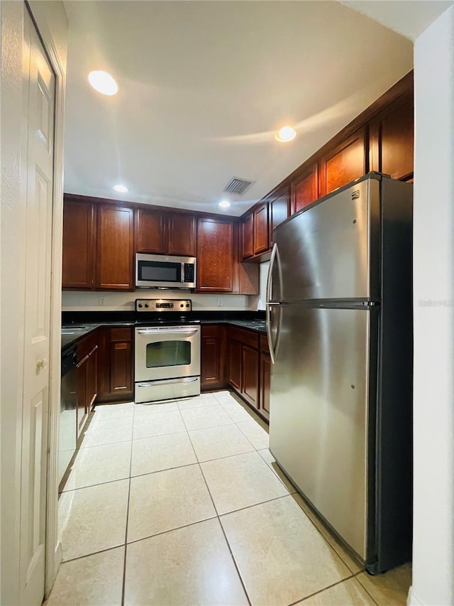 kitchen with light tile patterned floors and stainless steel appliances