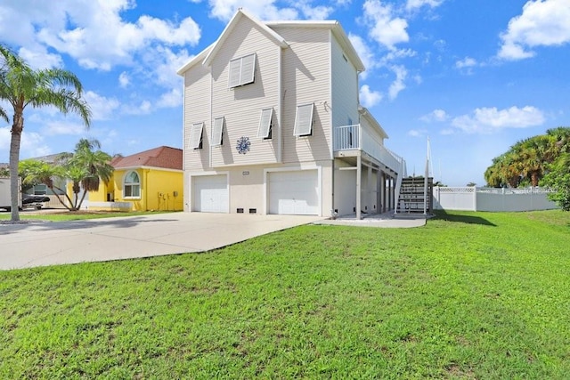 rear view of house featuring a garage and a yard