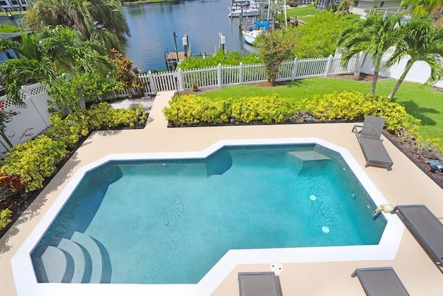 view of swimming pool featuring a water view and a lawn