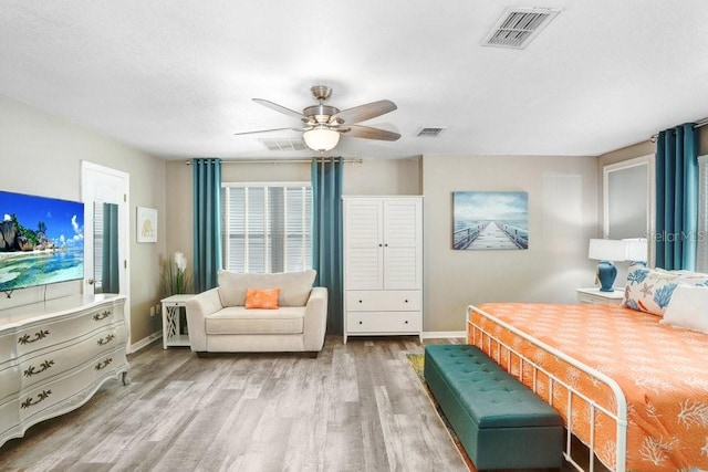 bedroom with ceiling fan and hardwood / wood-style floors