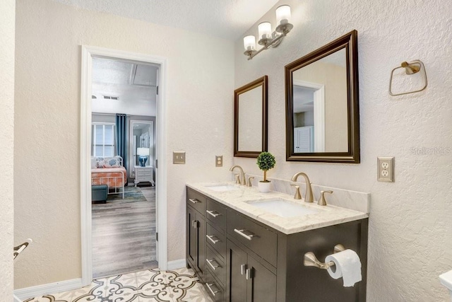 bathroom featuring dual vanity, a textured ceiling, and hardwood / wood-style floors