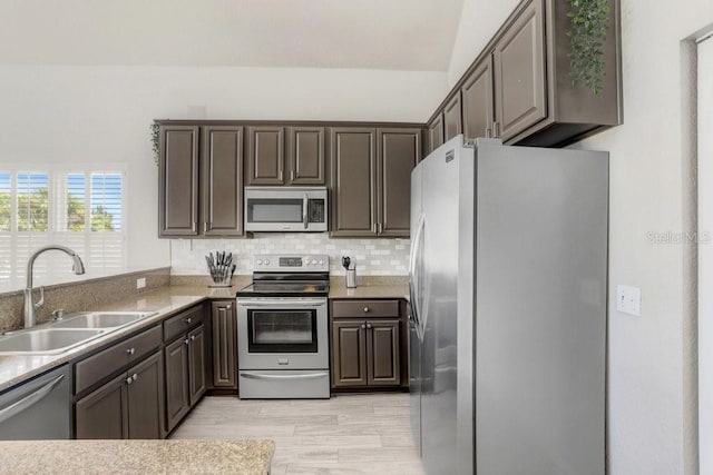 kitchen featuring stainless steel appliances, dark brown cabinets, and sink