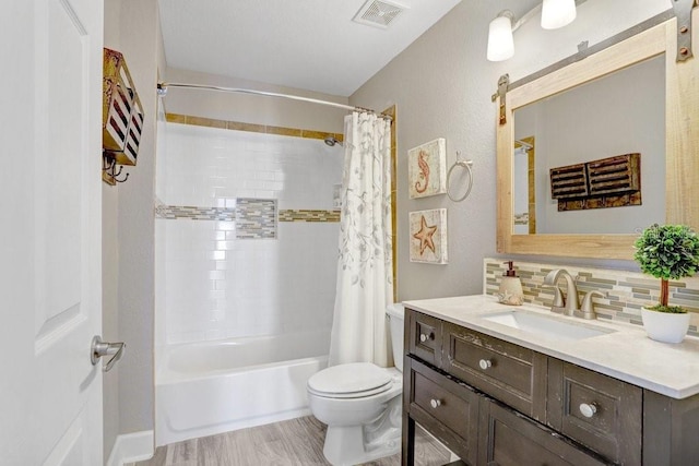 full bathroom featuring toilet, vanity, shower / tub combo with curtain, decorative backsplash, and wood-type flooring