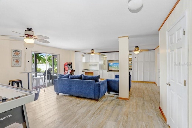 living room with ceiling fan and light wood-type flooring