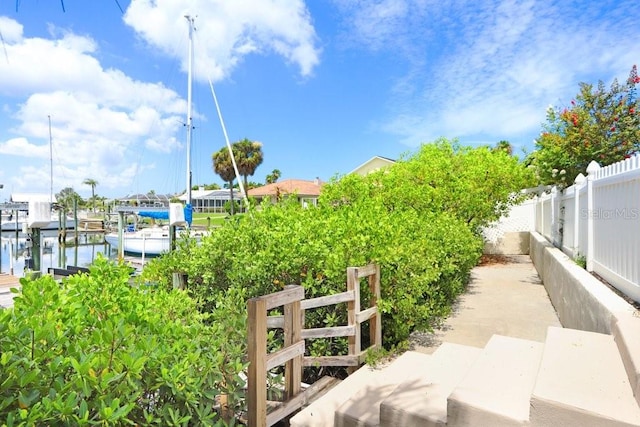 exterior space with a boat dock and a water view