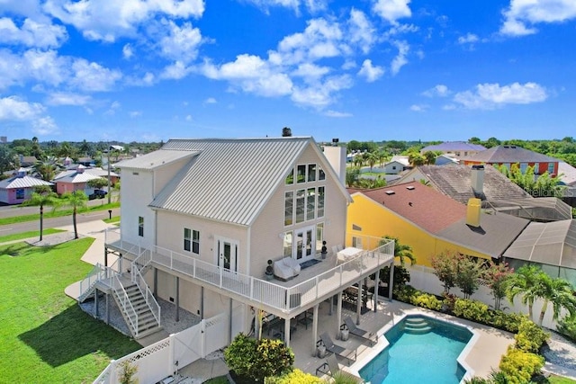 rear view of house featuring a patio area and a yard