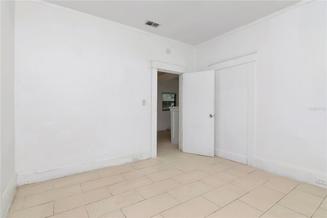 empty room featuring crown molding