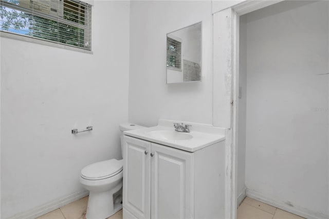 bathroom with vanity, tile patterned floors, and toilet