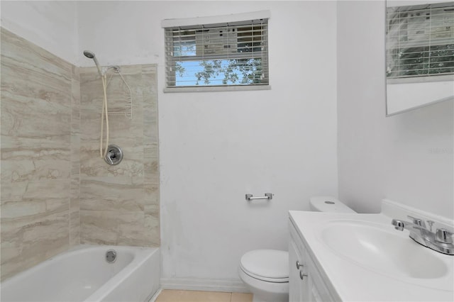 full bathroom featuring tiled shower / bath, vanity, and toilet