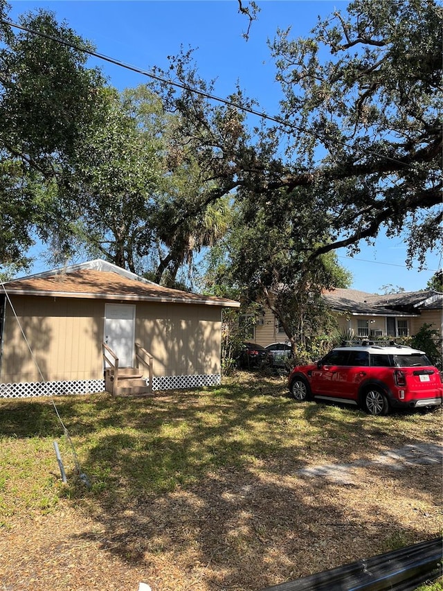 view of side of home with a yard