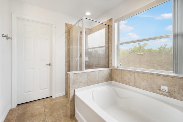 bathroom featuring tile patterned flooring and separate shower and tub