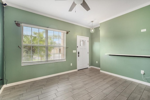 entrance foyer with crown molding, wood finish floors, a ceiling fan, and baseboards