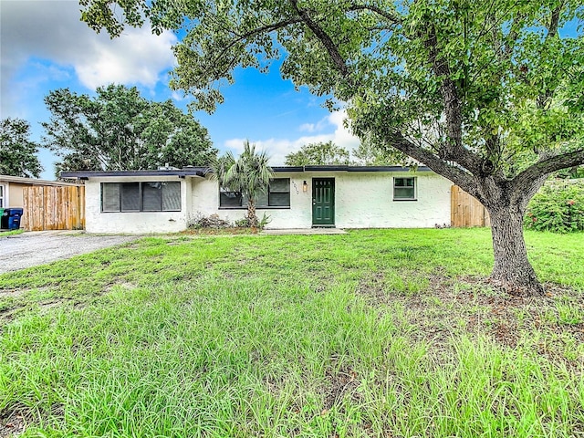 ranch-style home with a front yard