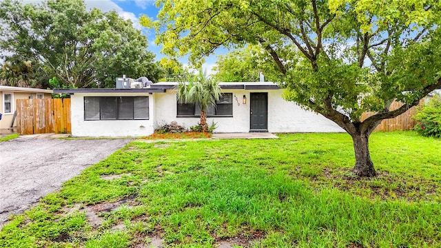 ranch-style home with a front lawn